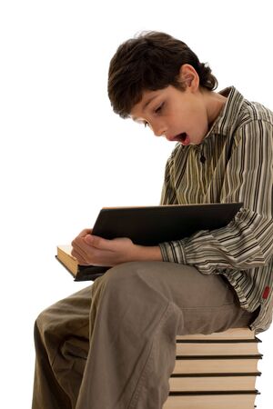 A reading boy has found an unexpected fact in the bookの写真素材