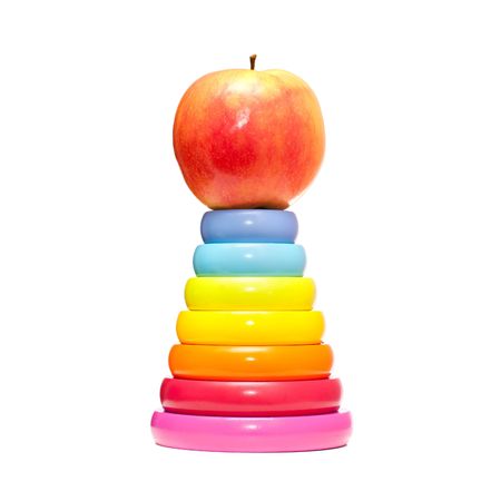 An apple is on the top of pyramid, isolated on the white backgroundの写真素材