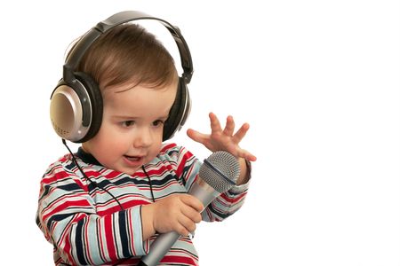 A speaking toddler with headphones and microphone; isolated on the white backgroundの写真素材