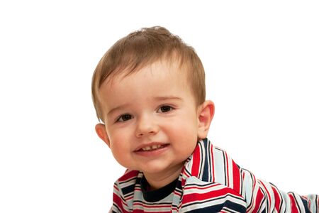 A smiling toddler in striped shirt; isolated on the white backgroundの写真素材