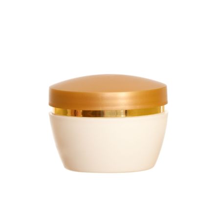 Golden and white cream vial isolated on the white backgroundの写真素材