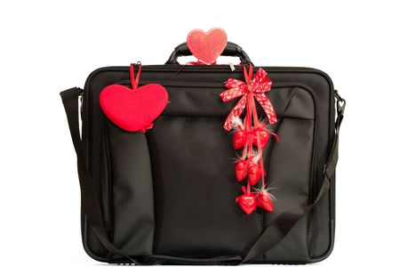 A black briefcase decorated with different valentines isolated on whiteの写真素材