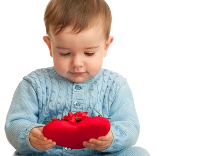 A little boy is looking at his first valentine; isolated on the whiteの写真素材