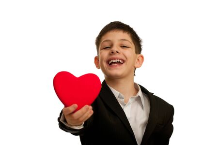 A happy smiling boy is holding a gift; isolated on the white backgroundの写真素材