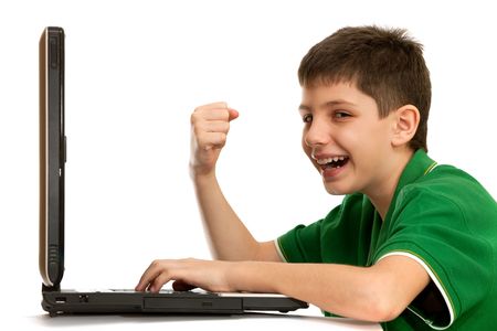 An emotional kid is playing a computer game; isolated on the white backgroundの写真素材