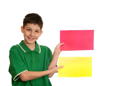 A boy is holding red and yellow sheets of paper in his hands; isolated on the white backgroundの写真素材