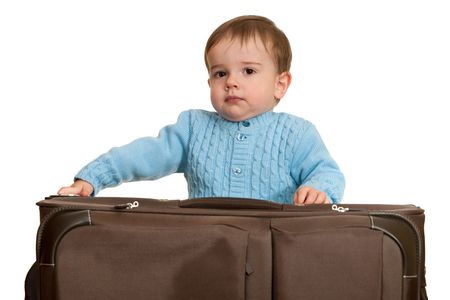 A toddler is packing a suitcase; isolated on the white backgroundの写真素材