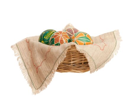 Easter eggs in a basket, isolated on the white backgroundの写真素材