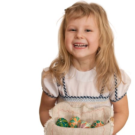 A girl is holding a basket with Easter eggs; isolated on the white backgroundの写真素材