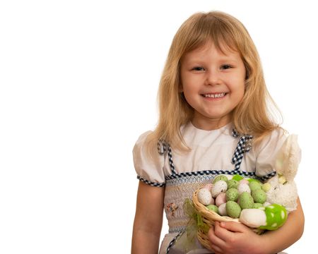 A smiling girl is holding a basket with Easter eggs and rabbit; isolated on the white backgroundの写真素材