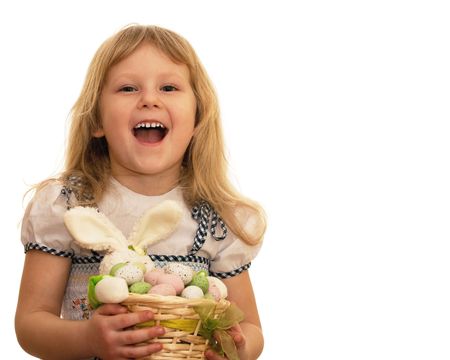 A laughing girl is holding a basket with Easter eggs and rabbit; isolated on the white backgroundの写真素材