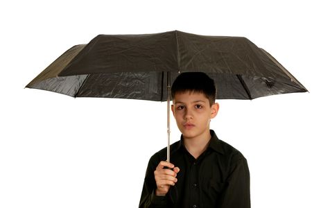 A teen in black is holding a black umbrella; isolated on the white background の写真素材