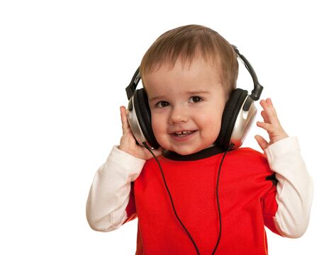 A smiling toddler is wearing headphones; isolated on the white backgroundの写真素材