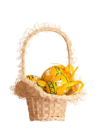 A basket of easter colored eggs; isolated on the white backgroundの写真素材