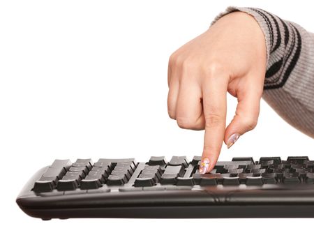 A woman's hand is pressing enter button on the pc keyboard; isolated on the white backgroundの写真素材