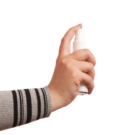 Woman's hand pressing aerosol; isolated on the white backgroundの写真素材