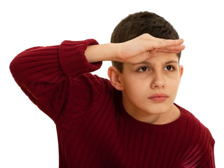 A kid is holding his hand at the head looking forward attentively; isolated の写真素材