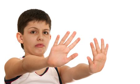 A sad boy is stretching out his hands rejecting some negative objects; isolated on the white backgroundの写真素材