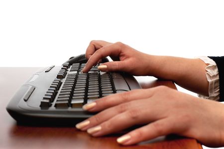 A woman's hand is on the keyboard; isolated on the white backgroundの写真素材