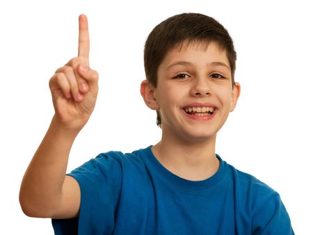 A smiling teen is pointing forward; isolated on the white backgroundの写真素材