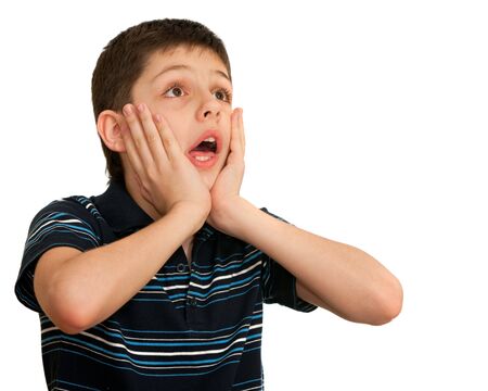 A shocked kid is holding his hands at his face; isolated on the white backgroundの写真素材