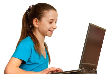 A pretty smiling girl is working on the laptop; isolated on the white backgroundの写真素材