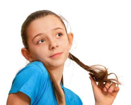 A surprised girl in blue is playing with her hair; isolated on the white backgroundの写真素材
