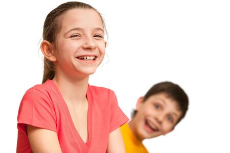A delighted boy is looking at a pretty girl in red; isolated on the white backgroundの写真素材