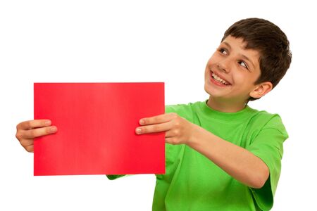 A smiling  boy is holding a sheet of red paper; isolated on the white backgroundの写真素材