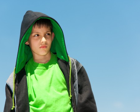 A thoughtful young hip-hop dancer is walking outdoorsの写真素材