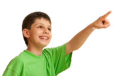 A laughing handsome boy is pointing forward; isolated on the white backgroundの写真素材