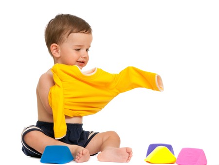 A toddler is wearing his yellow shirt; isolated on the white backgroundの写真素材
