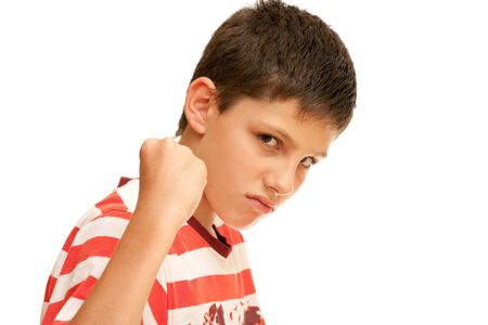 An angry boy is showing his fist; isolated on the white backgroundの写真素材