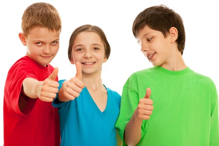 Three happy kids are holding their thumbs up; isolated on the white backgroundの写真素材