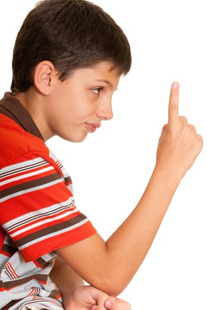 A closeup portrait of a disappointed boy with his pointer up; isolated on the white backgroundの写真素材