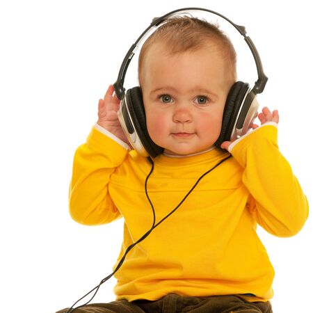 A little girl with headphones; isolated on the white backgroundの写真素材
