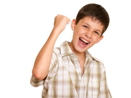 A happy handsome boy is holding his hand simbolizing victory; isolated on the white backgroundの写真素材