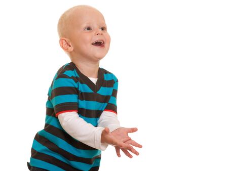 A  playing toddler is going to catch the ball; isolated on the white backgroundの写真素材
