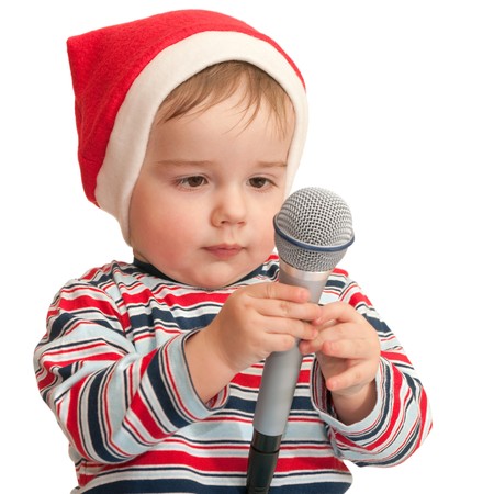 A portrait of a toddler dressed in a santa suit and holding microphone; isolated on the white backgroundの写真素材