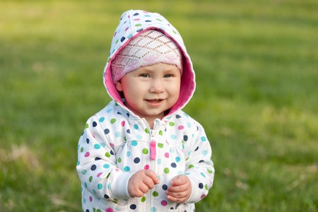 A smiling little girl in the autumn parkの写真素材