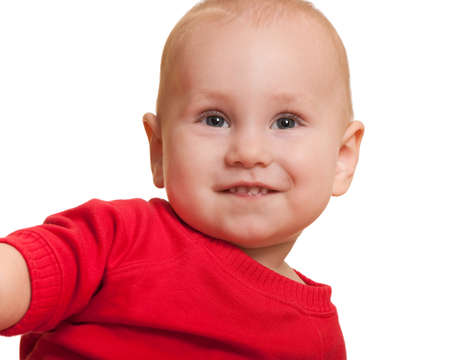 A portrait of a smiling little toddler in red; isolated on the white backgroundの写真素材