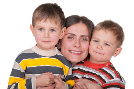 A pretty cheerful mother cuddles her twins; isolated on the white backgroundの写真素材