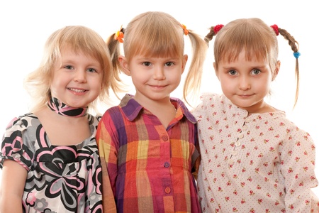 Three little girls in casual are smiling; isolated on the white backgroundの写真素材