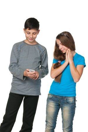 A portrait of fashion  teenagers with a cell phone; isolated on the white backgroundの写真素材