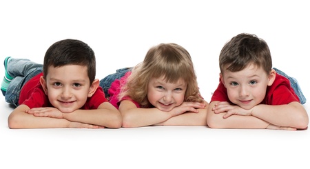 A portrait of a group of three cheerful children; on the white backgroundの写真素材