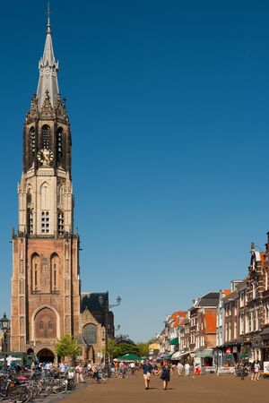 Delft, Netherlands - May 27, 2012: People walk near the New Church on the Delft Market Square. History of the construction of the New Church spans around three centuries and was finally completed in 1655. GPS information is in the file.のeditorial素材