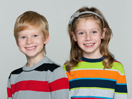 Two cheerful children on the white background
