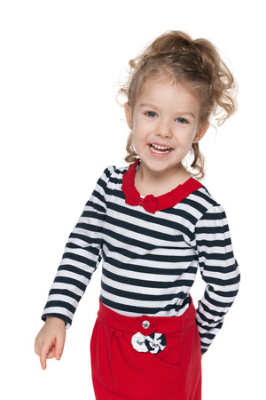 A portrait of a happy little girl in the striped blouse against the white backgroundの写真素材