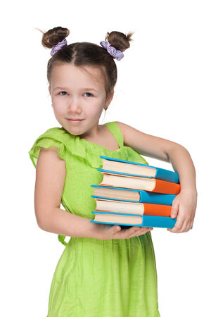 A portrait of a clever little girl with books against the white backgroundの写真素材