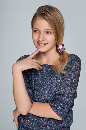 A portrait of a curious preteen girl on the white backgroundの写真素材